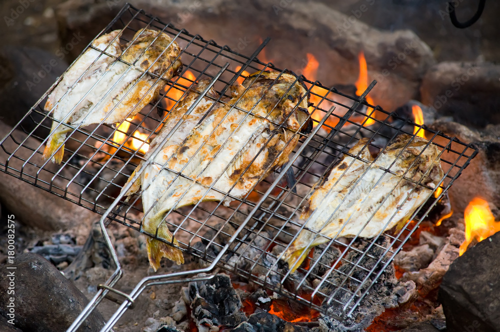 fish roasting on fire