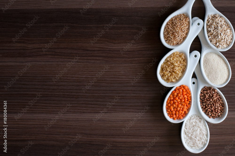 Cereals in a white dish on a dark wooden background. Cereals in a white dish on a dark wooden background.
