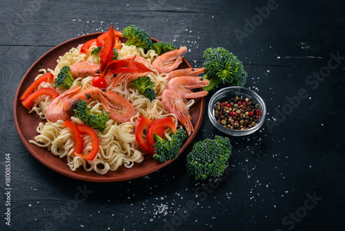 Asian food with seafood and vegetables. Shrimp, broccoli, paprika, spices. Top view. Free space for text.