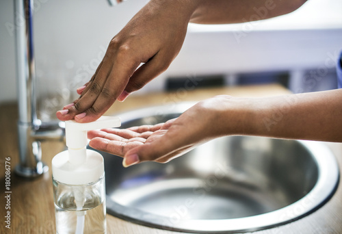 Closeup of hands washing with sanitize solution photo