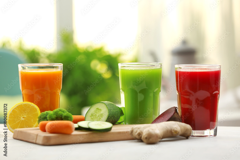 Fototapeta premium Glasses with various fresh vegetable juices on table