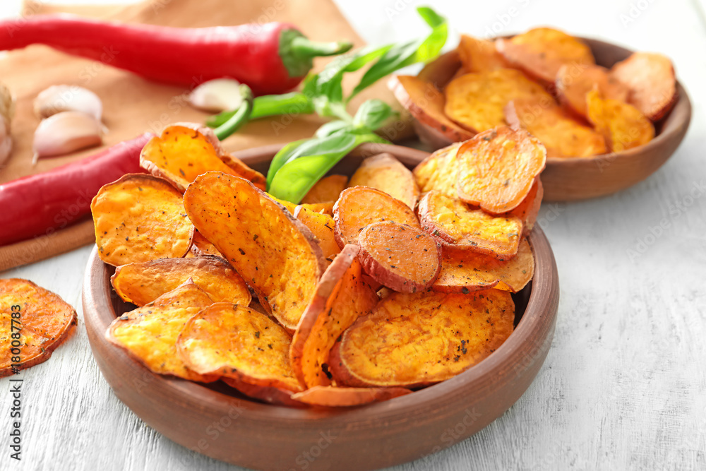Bowl with yummy sweet potato chips on table Bowl with yummy sweet potato chips on table