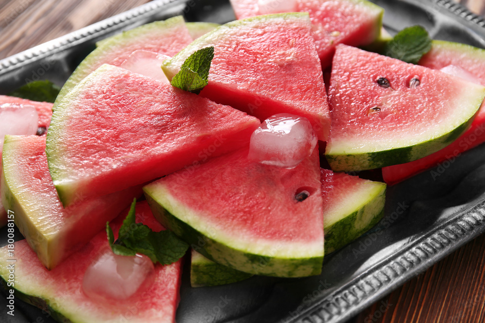 Tray with tasty sliced watermelon on table Tray with tasty sliced watermelon on table