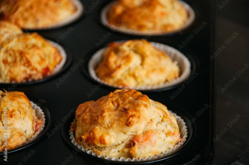 Homemade savory muffins with fish and cheese in a baking form. Healthy snack or breakfast meal.