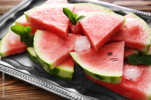 Tray with tasty sliced watermelon on table