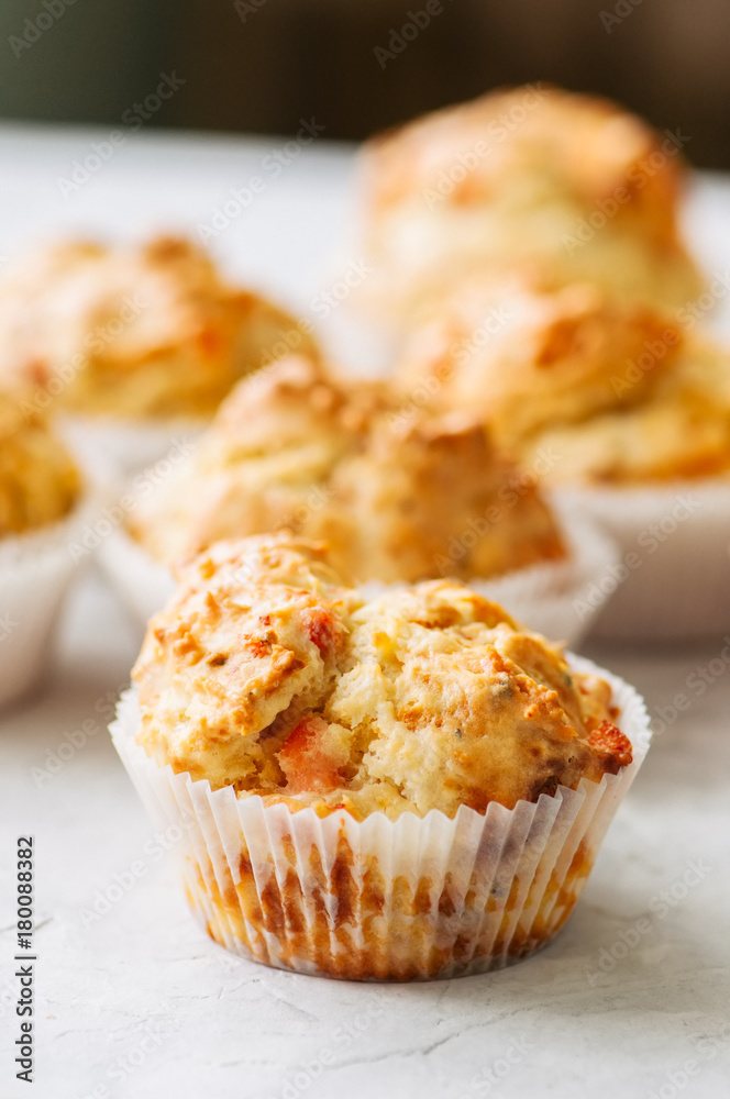 Homemade savory muffins with fish and cheese on a white stone background. Healthy snack or breakfast meal.