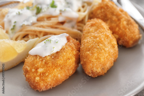 Plate with tasty salmon croquettes, closeup