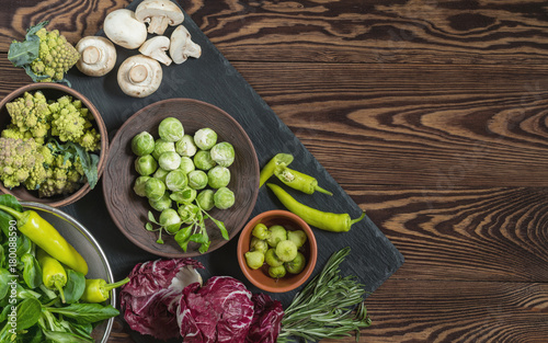 Fotografie Variety of organic fresh vegetables on wooden background