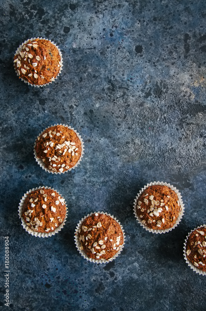 Healthy carrot cake muffins on a blue stone background. Top view. Healthy carrot cake muffins on a blue stone background. Top view.