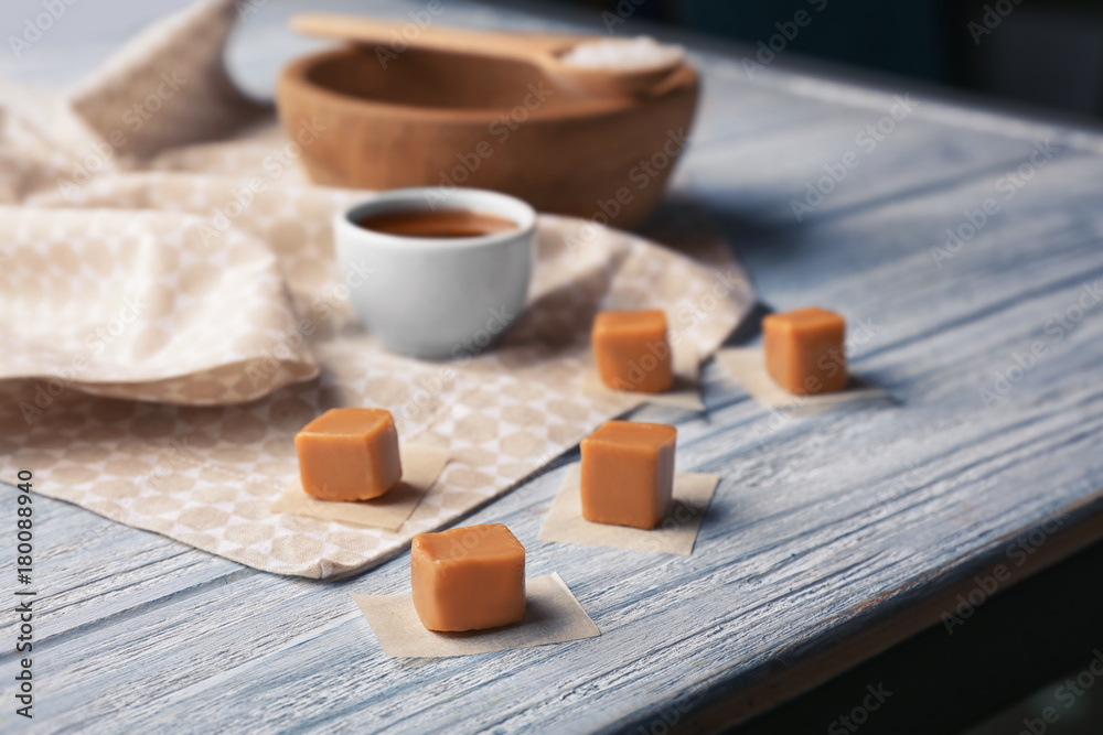 Sweet caramel candies on wooden table