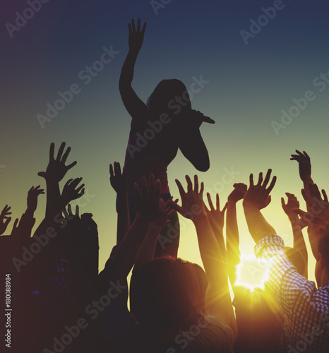 Silhouettes of a music concert at sunset