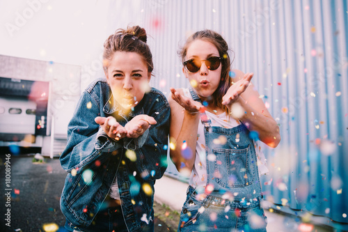 Friends celebrating with confetti outdoors photo