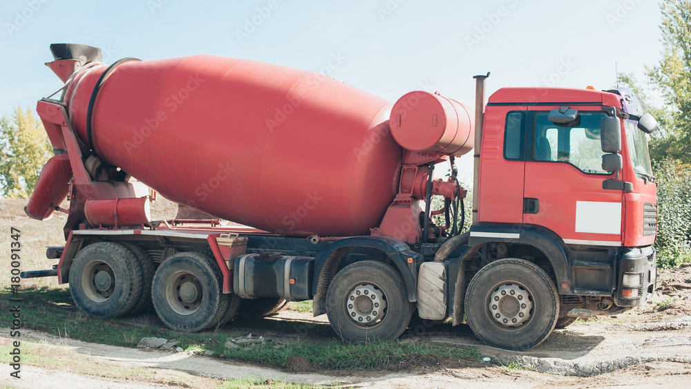 Red concrete mixer vehicle on the construction site Red concrete mixer vehicle on the construction site