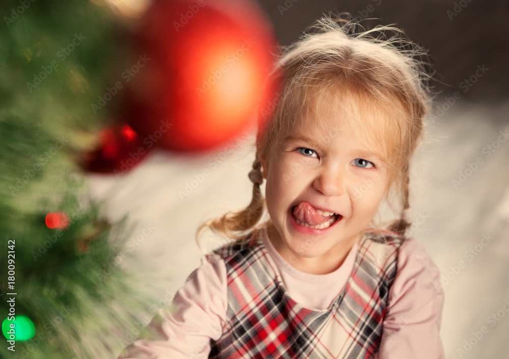 Pretty little child near Christmas tree. Pretty little child near Christmas tree.