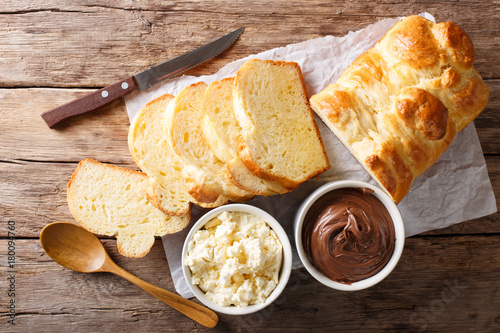 Freshly brioche bread and cream cheese, chocolate cream. horizontal top view photo