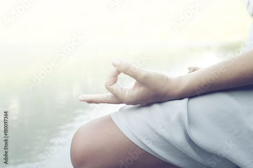 woman doing yoga exercises in front of a spectacular mountain lake