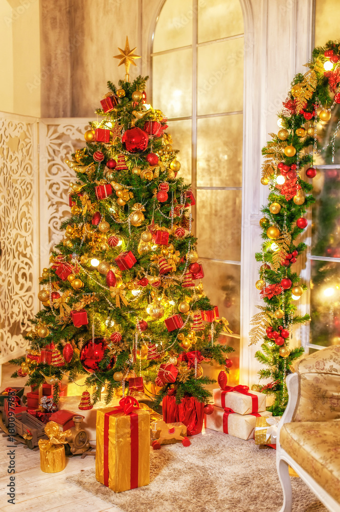 Christmas shining tree with decorations, tinsel, star, balls. Interior in vintage style. New year holidays.