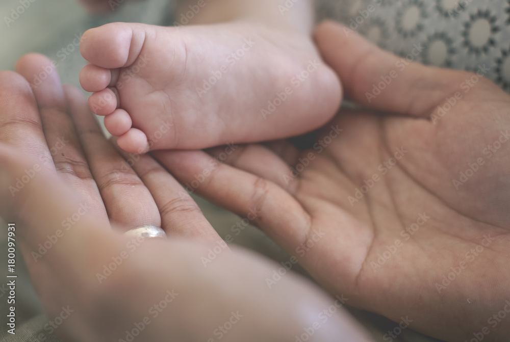 Father and mother are taking care of their child. Father and mother are taking care of their child.