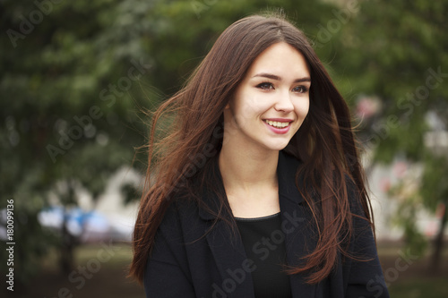 Young beautiful brunette girl in the autumn park