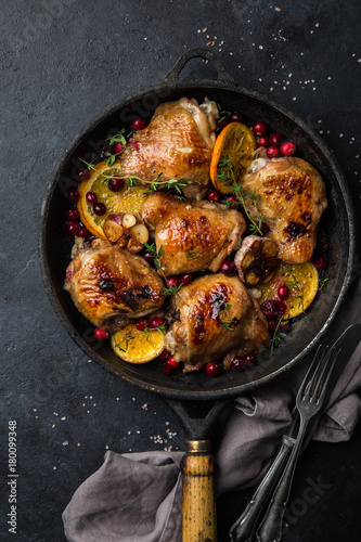roasted  chicken with orange, cranberry and spicy herbs on pan
