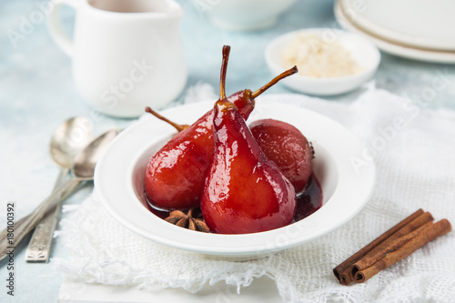 delicious red wine poached pears in spicy syrup photo