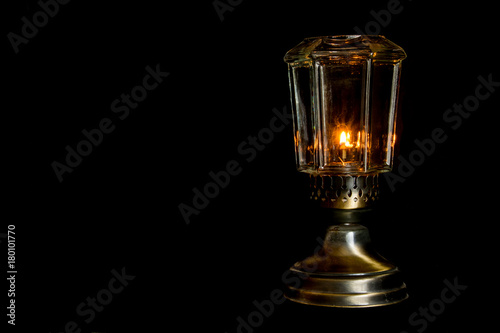An oil lamp on a black background.