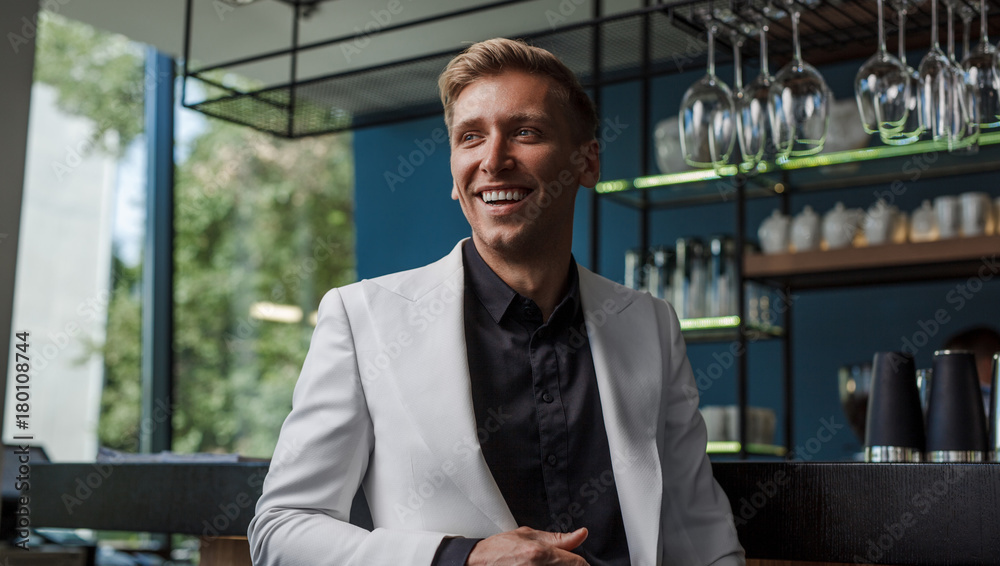 Fototapeta premium Cheerful handsome man in bar