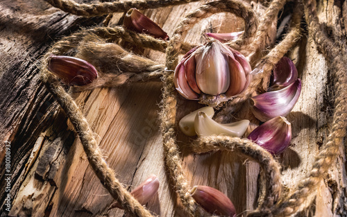 Garlic whole and cloves on the wooden background
