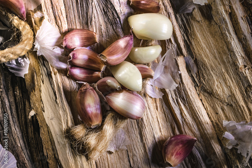 Garlic whole and cloves on the wooden background
