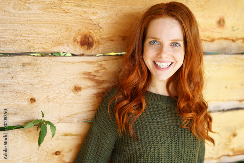 glückliche frau mit langen roten haaren und blauen augen photo