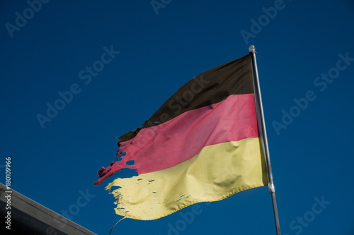 Torn flag of Germany fluttering photo