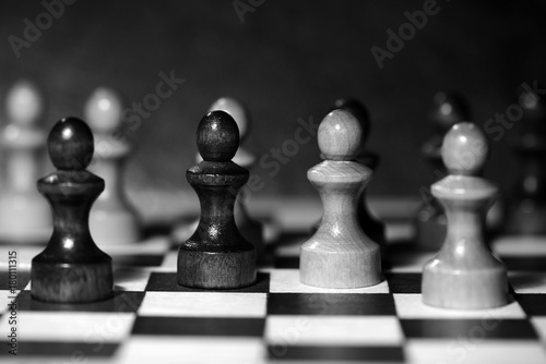 Chess figures on a chessboard. Black and white