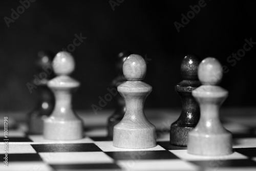 Chess figures on a chessboard. Black and white