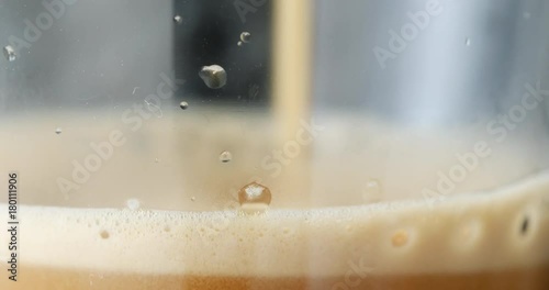Processed espresso made and served, filmed in big macro close-up