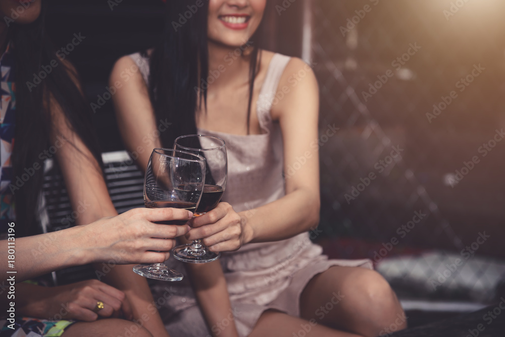 Closeup Hand Hold and Clinking Wine Glass in Cheerful Party in Restaurant Closeup Hand Hold and Clinking Wine Glass in Cheerful Party in Restaurant