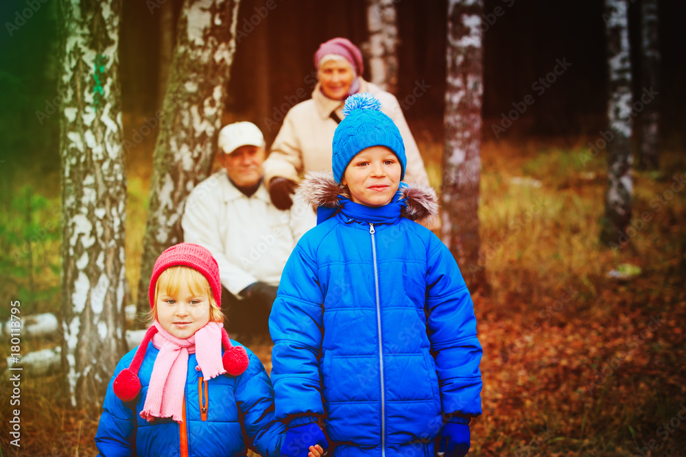 grandparents with kids walk in nature