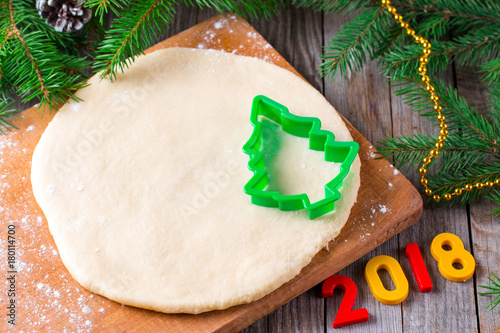 Christmas background new year 2018, dough and cookie cutters. Top view photo