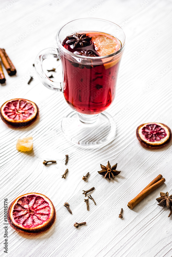 mulled wine with spices in cup on wooden background mulled wine with spices in cup on wooden background