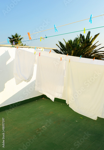 White sheets on the terrace clothesline photo