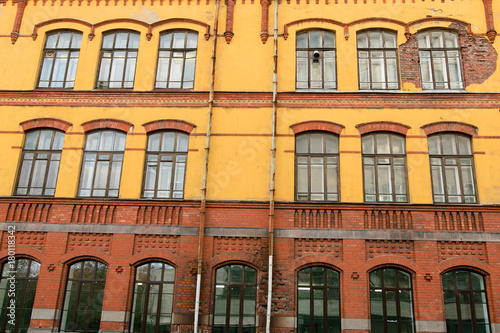 Facade of old yellow-red building in Vyborg, Russia
