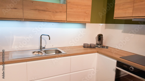 The interior of the modern kitchen in wood and white