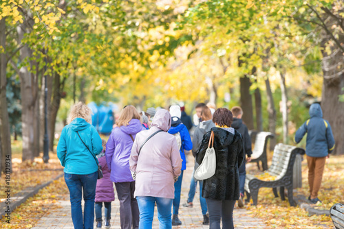 Crowd of people walking in park