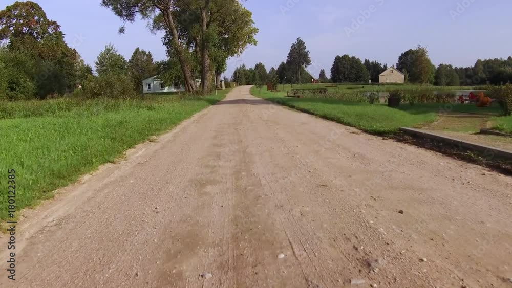 Dirt road passing along the houses in the country side Dirt road passing along the houses in the country side