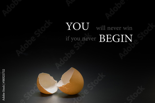broken egg on black background and epigram