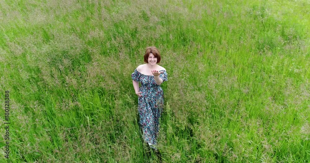 Woman invites you to follow along the field Woman invites you to follow along the field