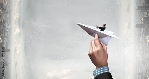 Woman pilot in paper plane. Mixed media