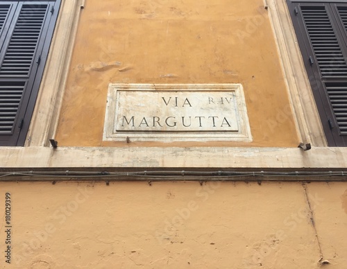 Via Margutta street name sign. Via Margutta is a narrow street in the centre of Rome, Italy, near Piazza del Popolo, accessible from Via del Babuino photo