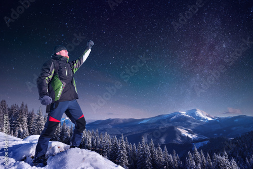 Traveler in the mountains in winter hand up Night frame, Milky way star,