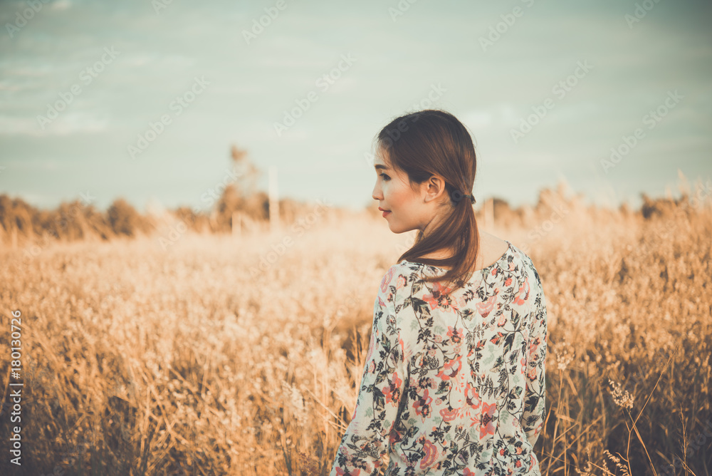 Asian woman feeling sad from unrequire love in the field.,breakheart girl concept,outdoor. Asian woman feeling sad from unrequire love in the field.,breakheart girl concept,outdoor.