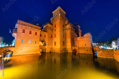 Ferrara, Italy - 22.06.2017: Night Castle Estensi and reflection in the water photo